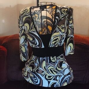 Women's 3/4 sleeve v front, smooch like dress blouse. Tires in the back.